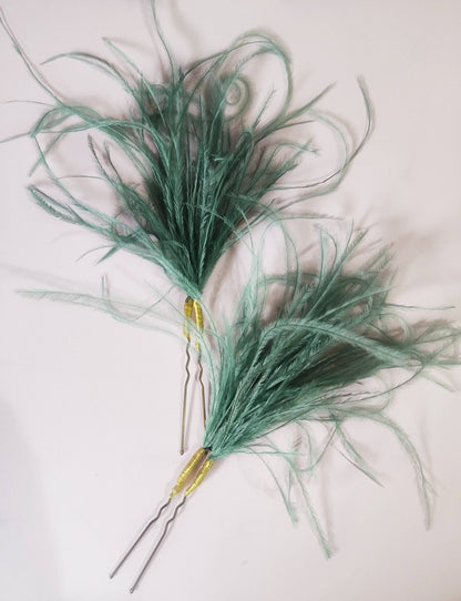 Par de horquillas con plumas verde azulado 
